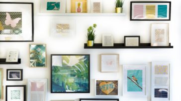 assorted-color framed paintings on the wall