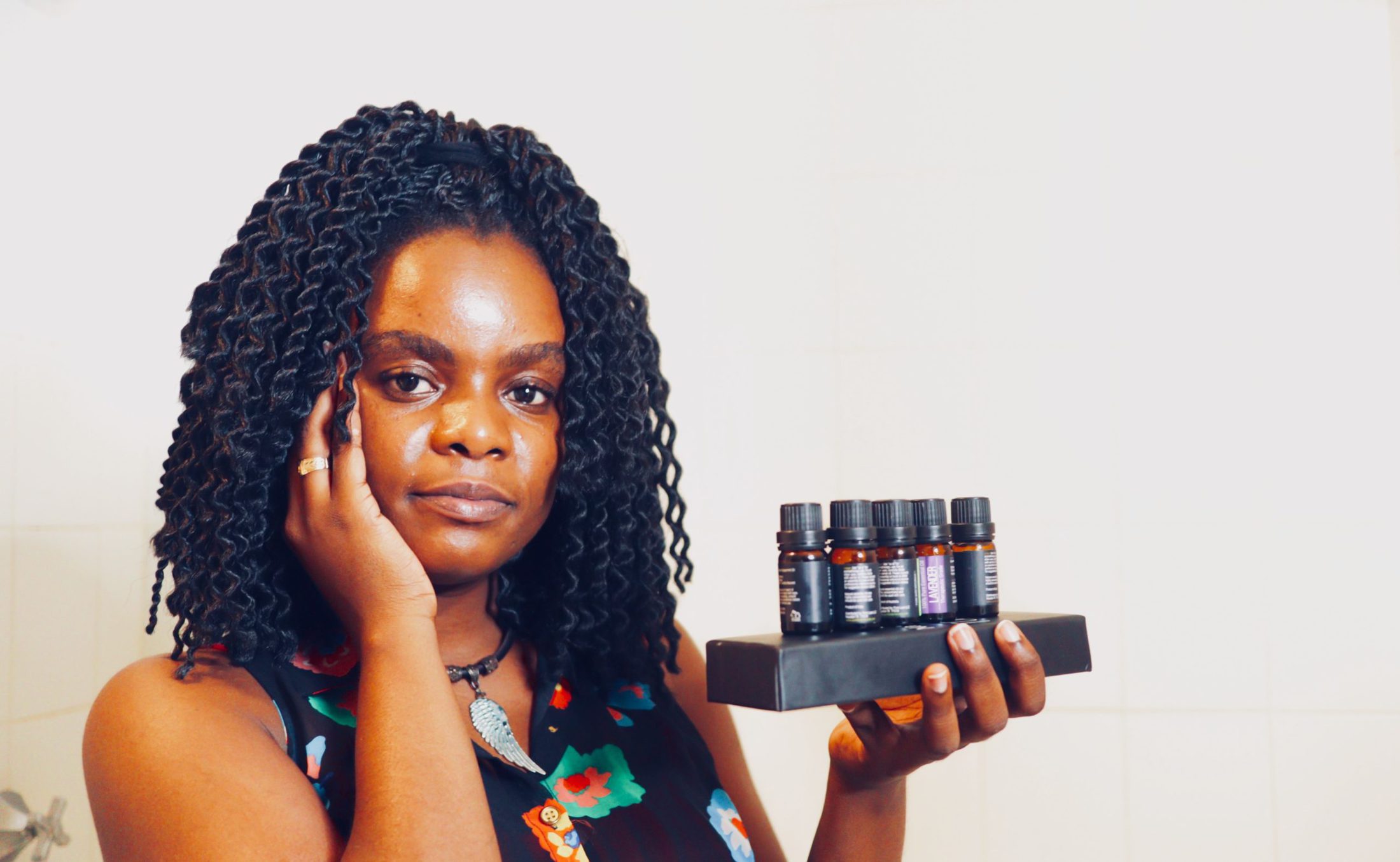 woman holding variety of oils