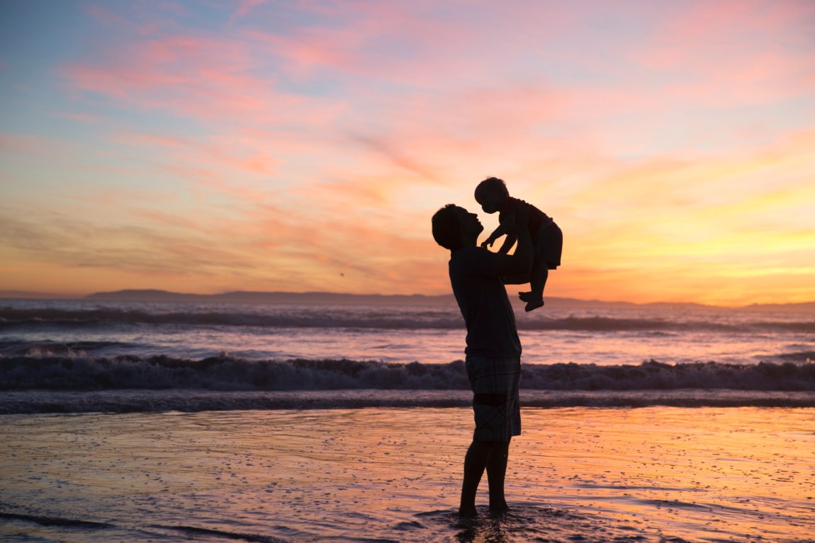 silhouette of man and kid