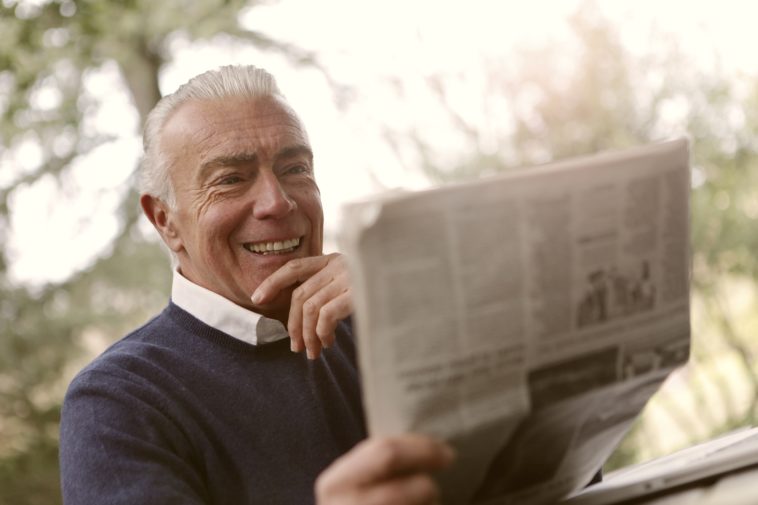 Old age man reading newspaper