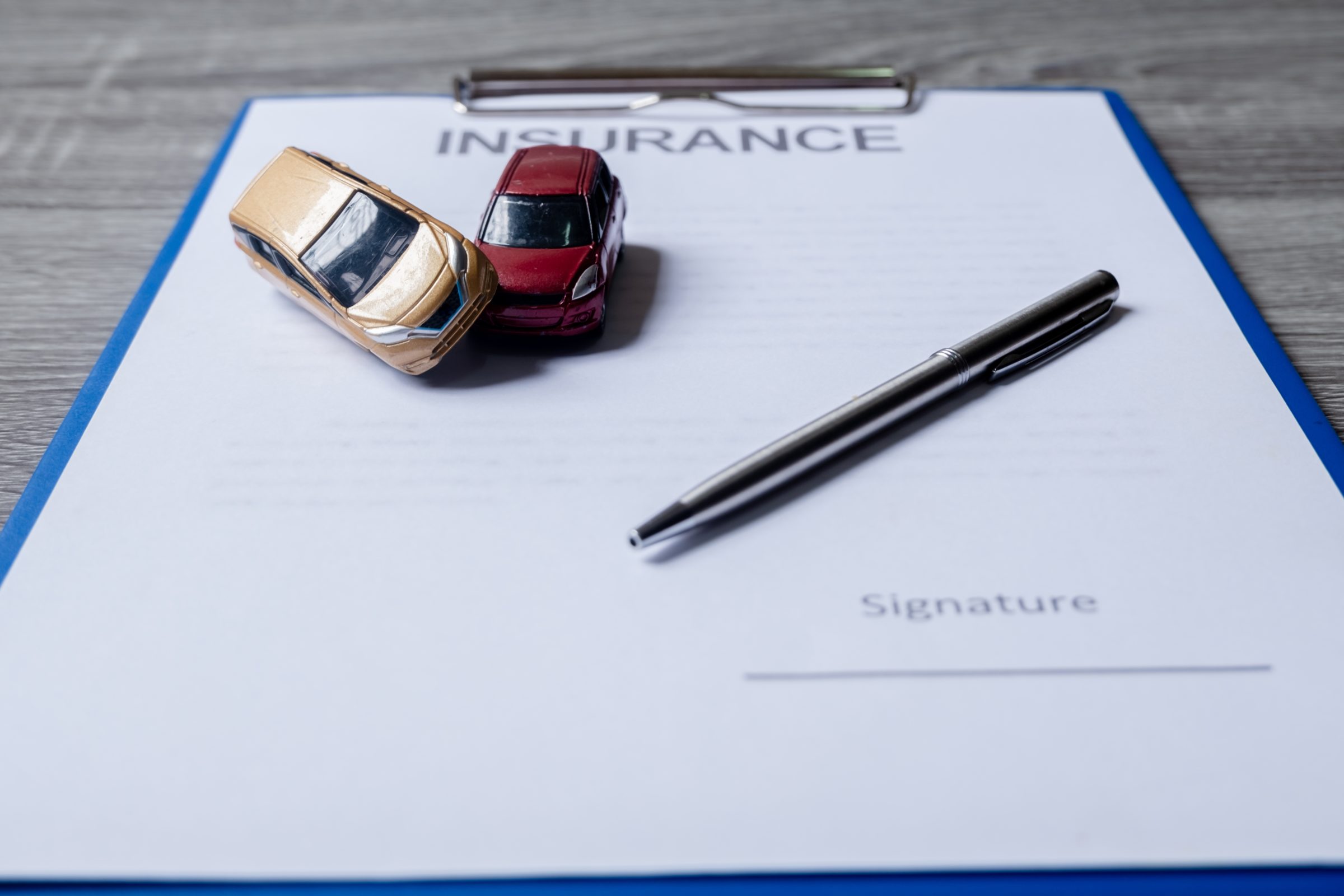 car and pen on insurance documents car insurance c 7SAPSYA