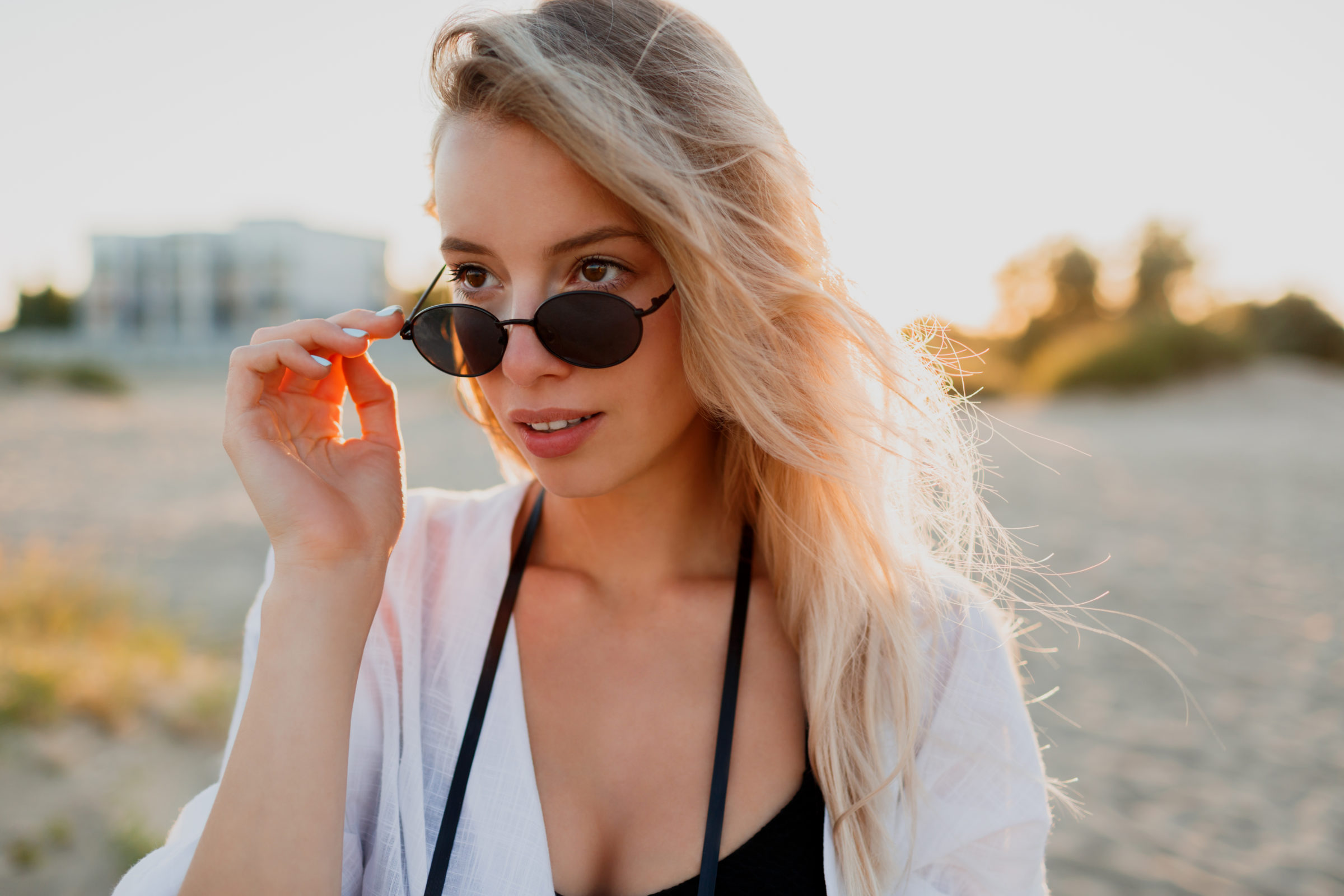 stylish blonde woman in sunglasses DZ6MESU