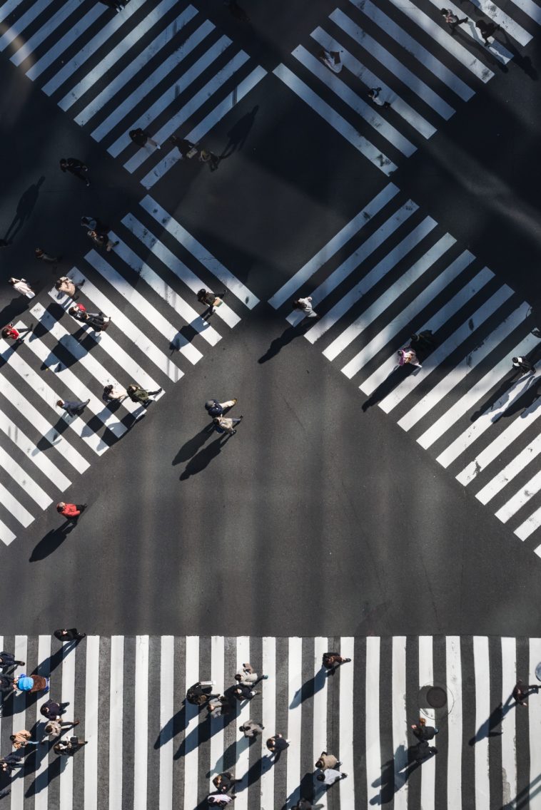 Czechs aerial photography of people walking in the intersection street during daytime