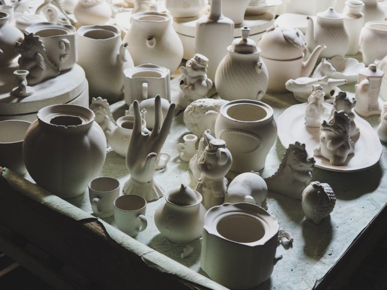 white ceramic mugs on white wooden shelf