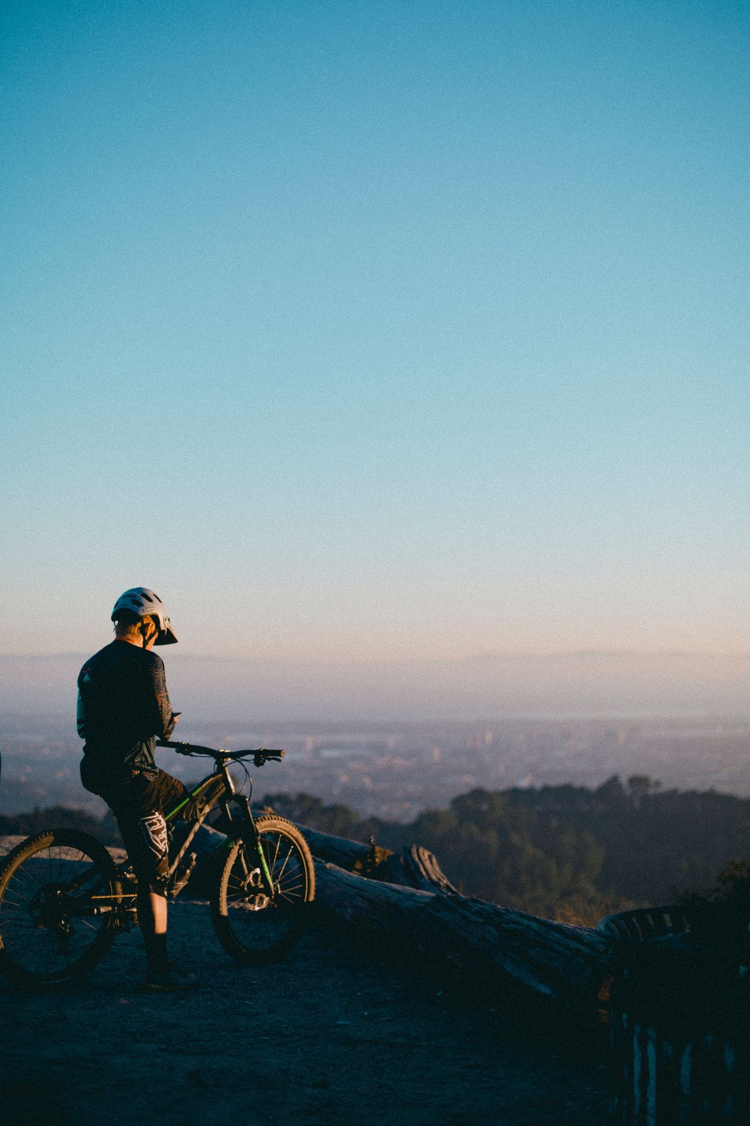 man riding on bicycle while standing on peak