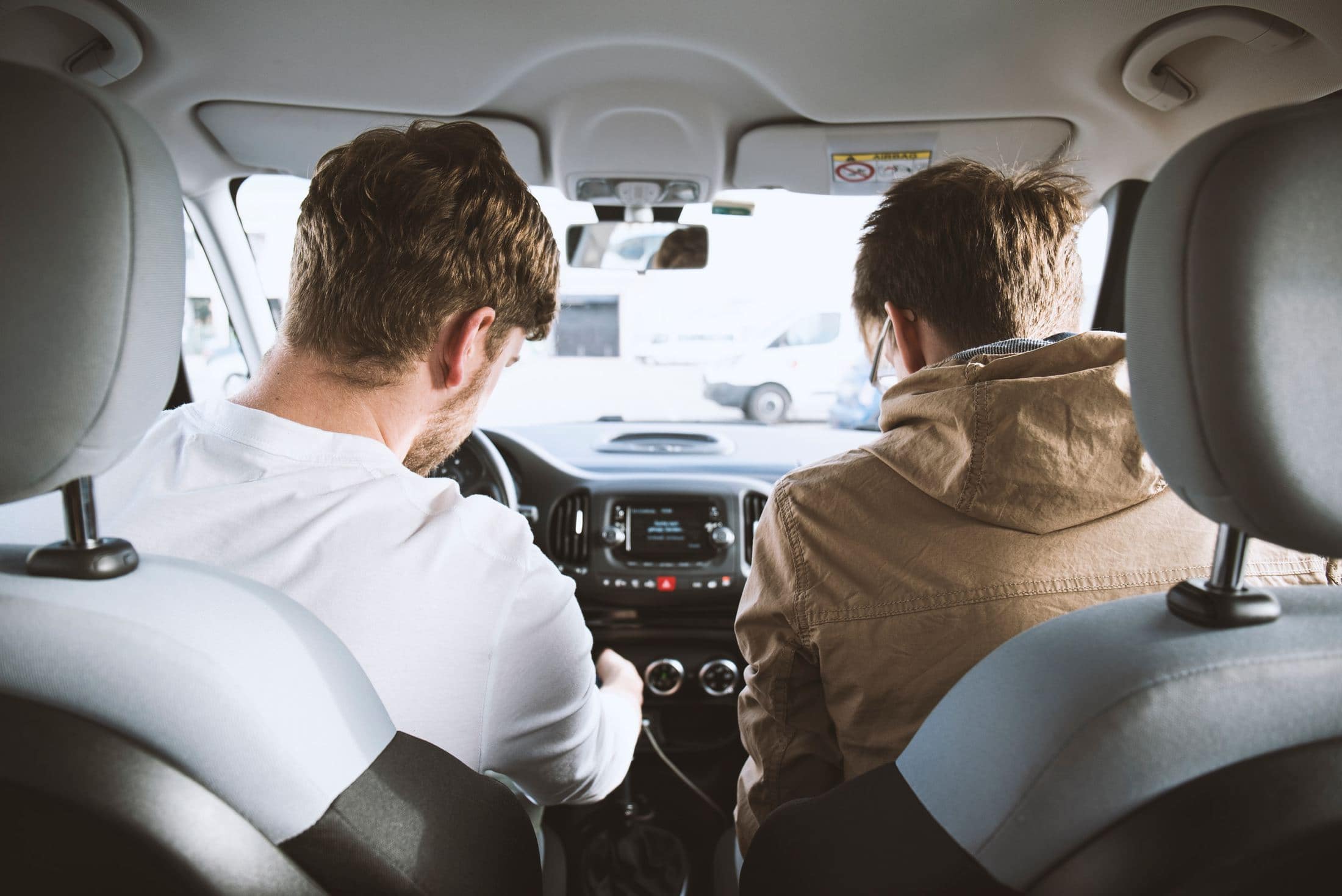 two men sitting inside vehicle