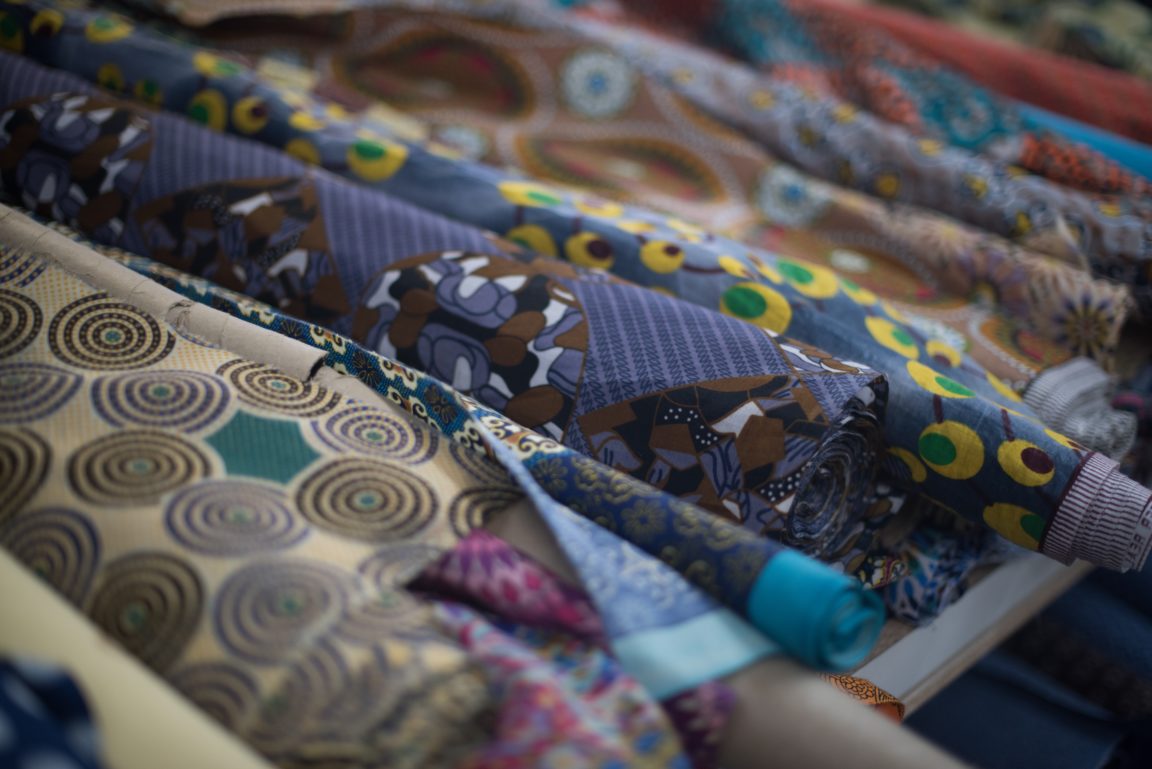 assortment of african print cloth on rack 9KT36TG