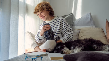 cheerful boy with vintage photo camera and dog on KQBQXTS