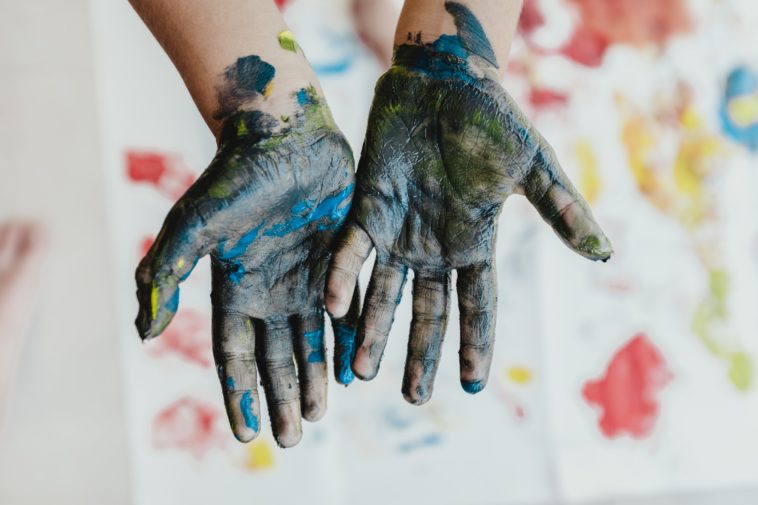 Fingerpaint person hands with green paint