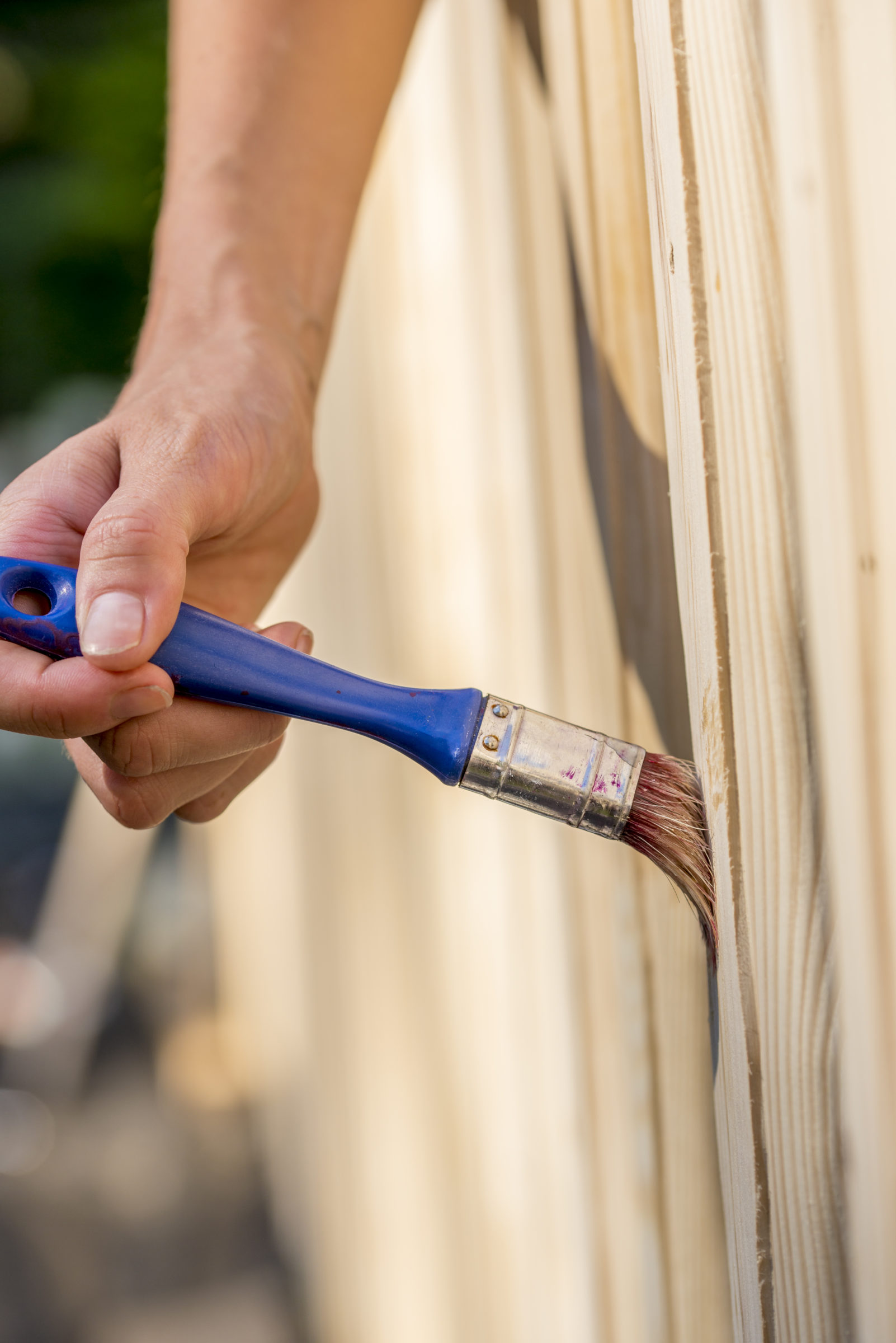 person varnishing an exterior garden fence 2021 08 26 22 28 00 utc