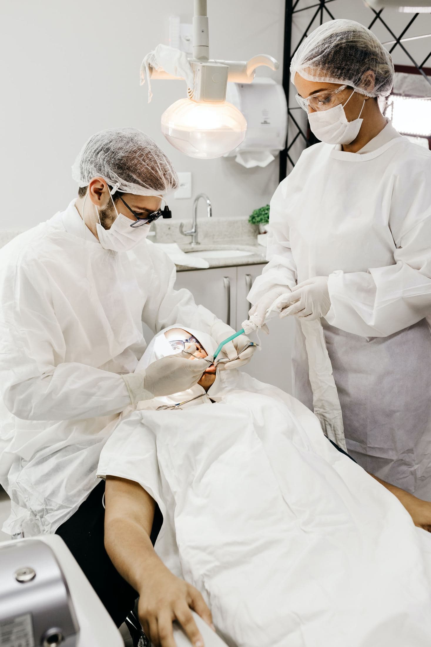 How to Find the Best Dental Practice for You woman in white scrub suit holding white and green hose