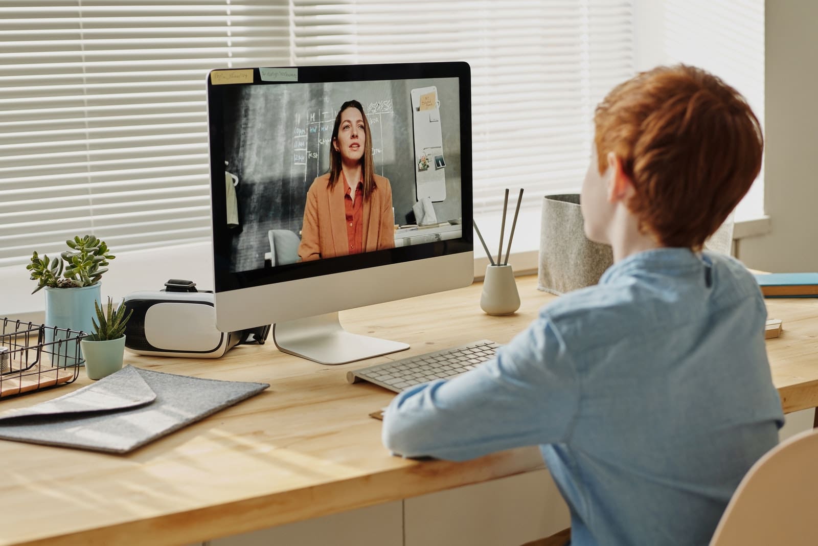 How to Make Online Learning Enjoyable photo of child sitting by the table while looking at the imac