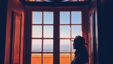 woman standing beside window