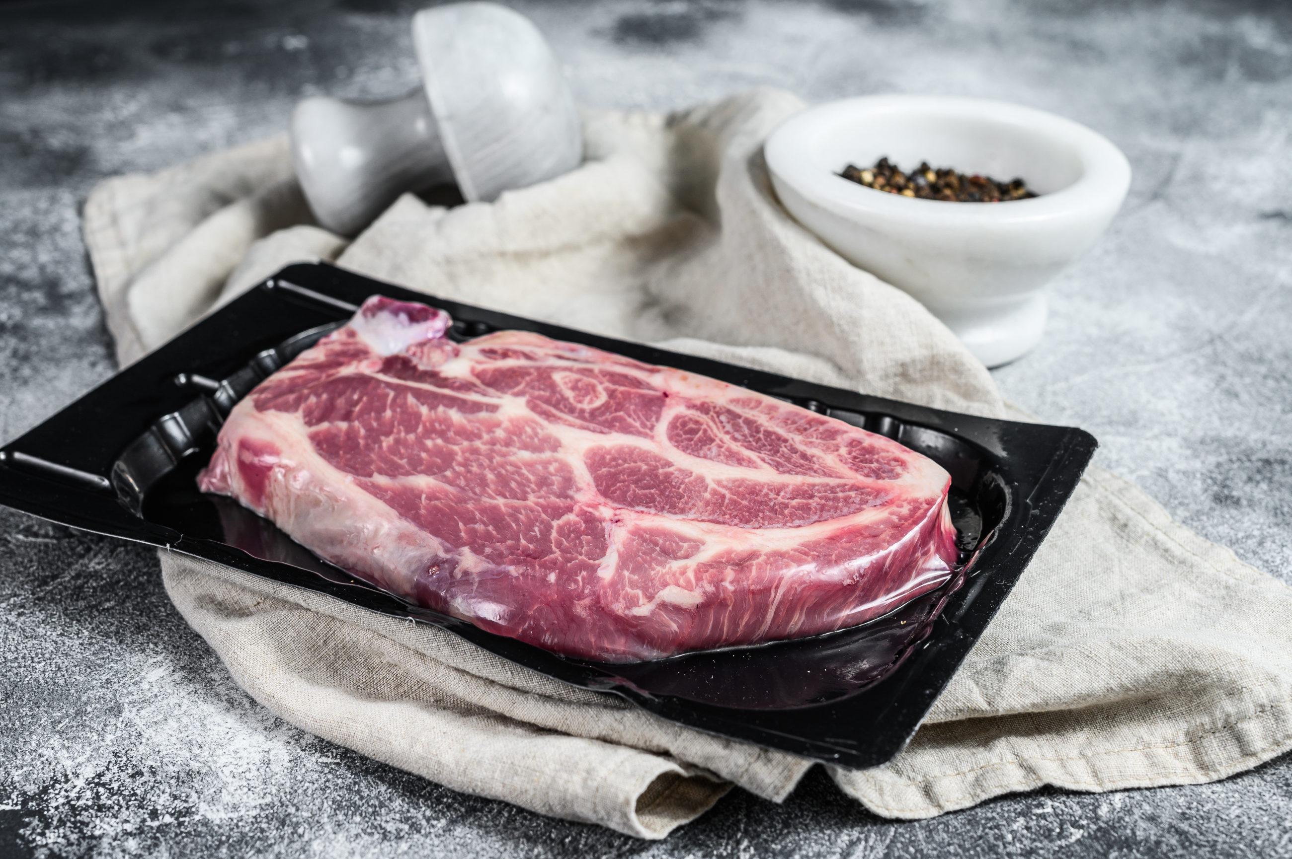 unopened vacuum pack of pork steak isolated on bla 2021 12 09 10 54 02 utc