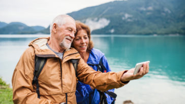a senior pensioner couple standing by lake in natu 2022 02 02 04 48 41 utc