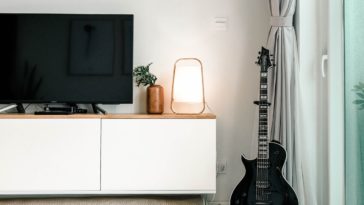 black flat screen tv on white wooden tv rack