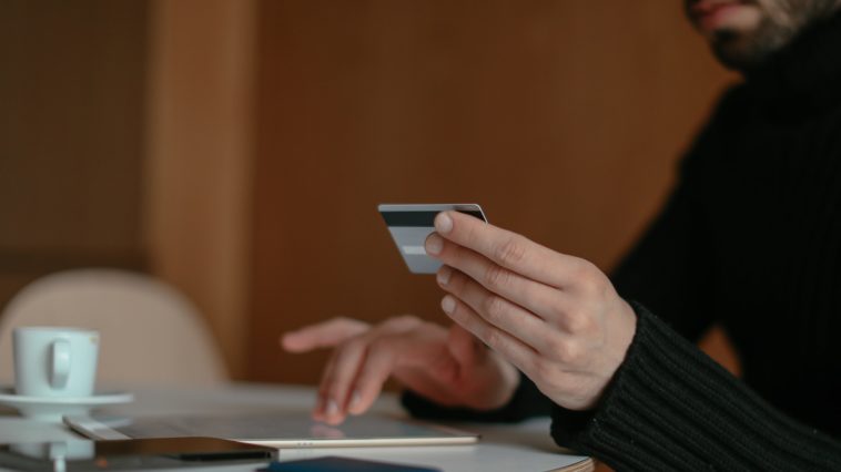 Close up of a Man Using a Bank Card Online