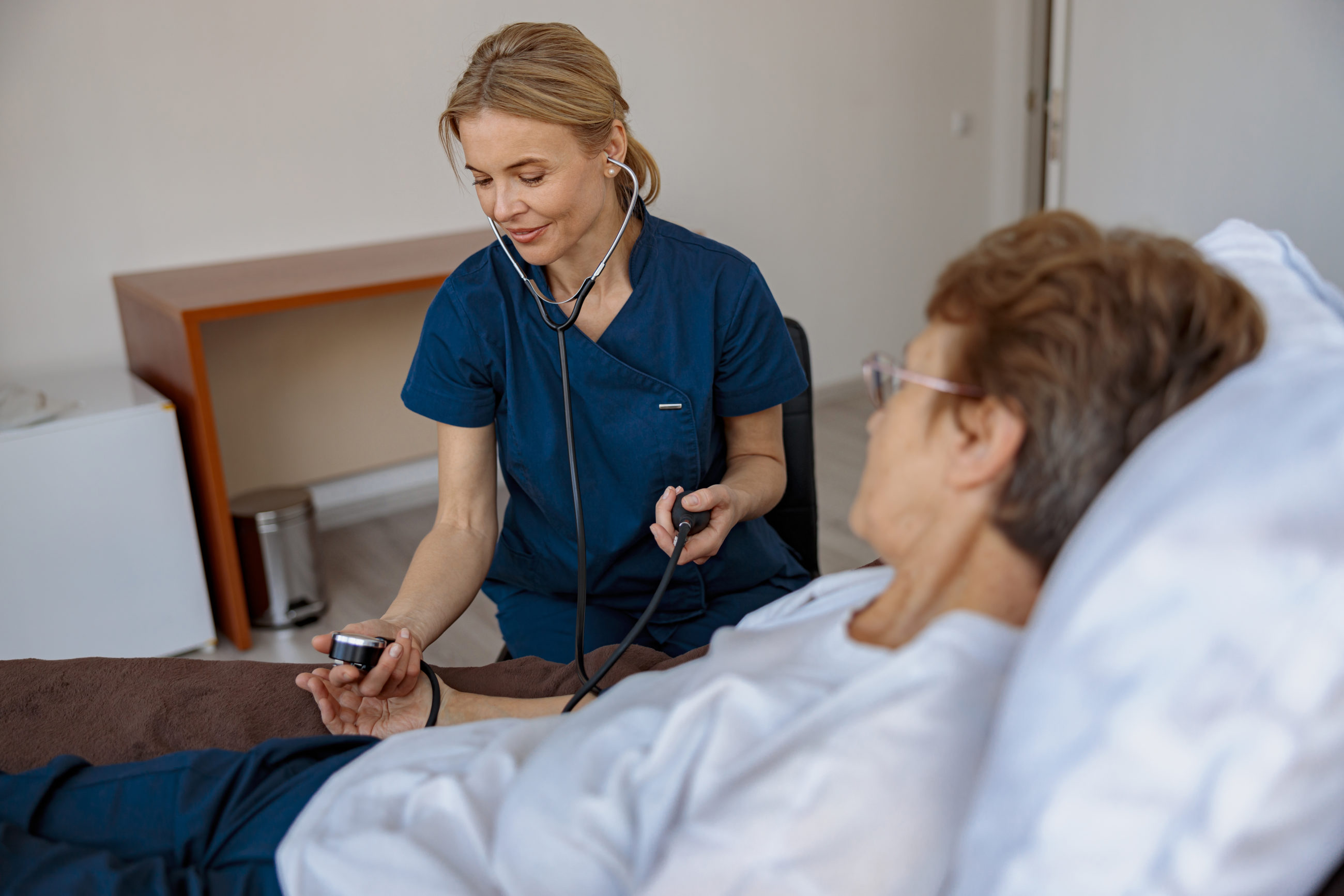 female nurse checking blood pressure of senior wom 2022 06 24 14 22 41 utc