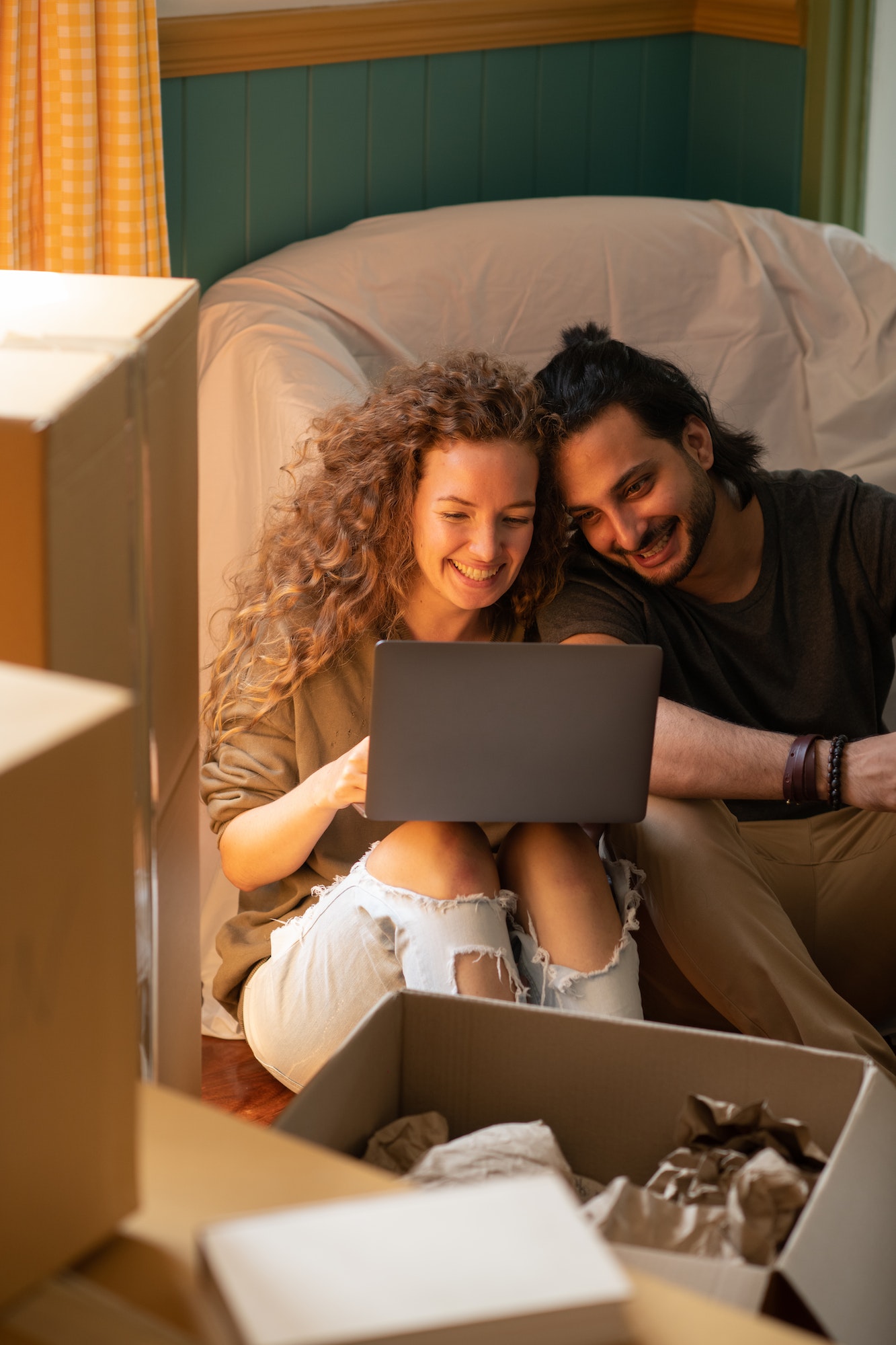The Top Mistakes Landlords Make When Renting Out Properties happy diverse couple using laptop while relocating into new apartment