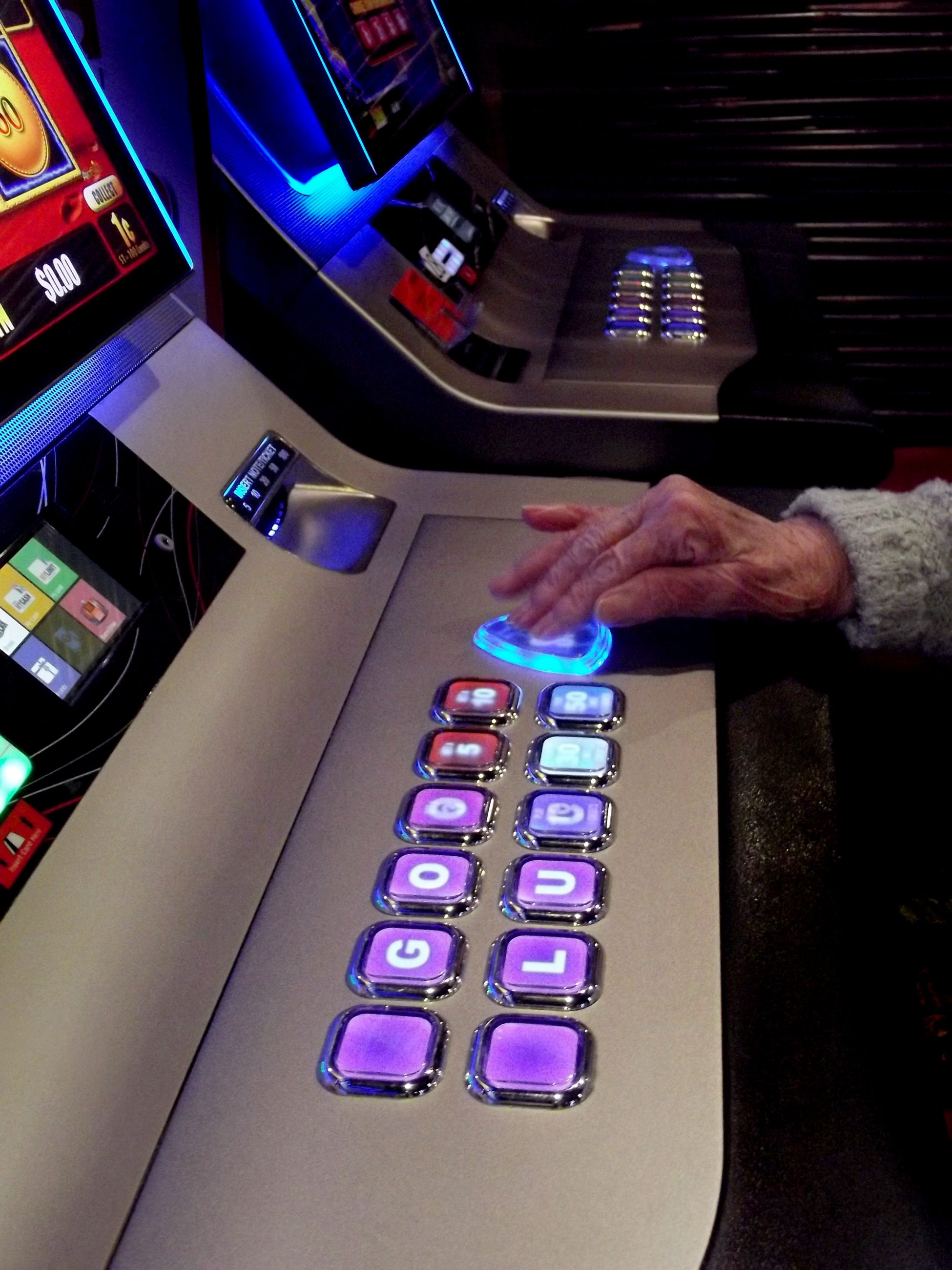 elderly lady playing a casino slot machine 2021 08 30 09 06 15 utc