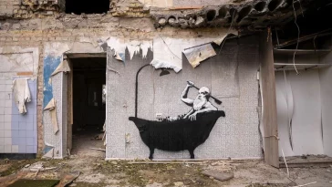 a cow is standing in front of a building
