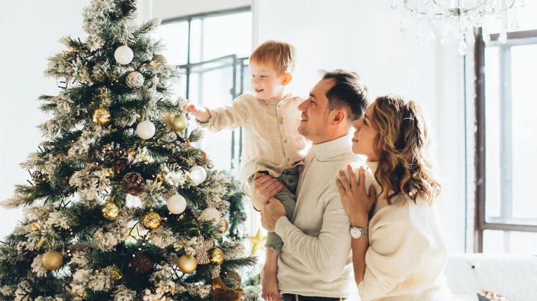 Couple with Their Son Looking at a Christmas Tree