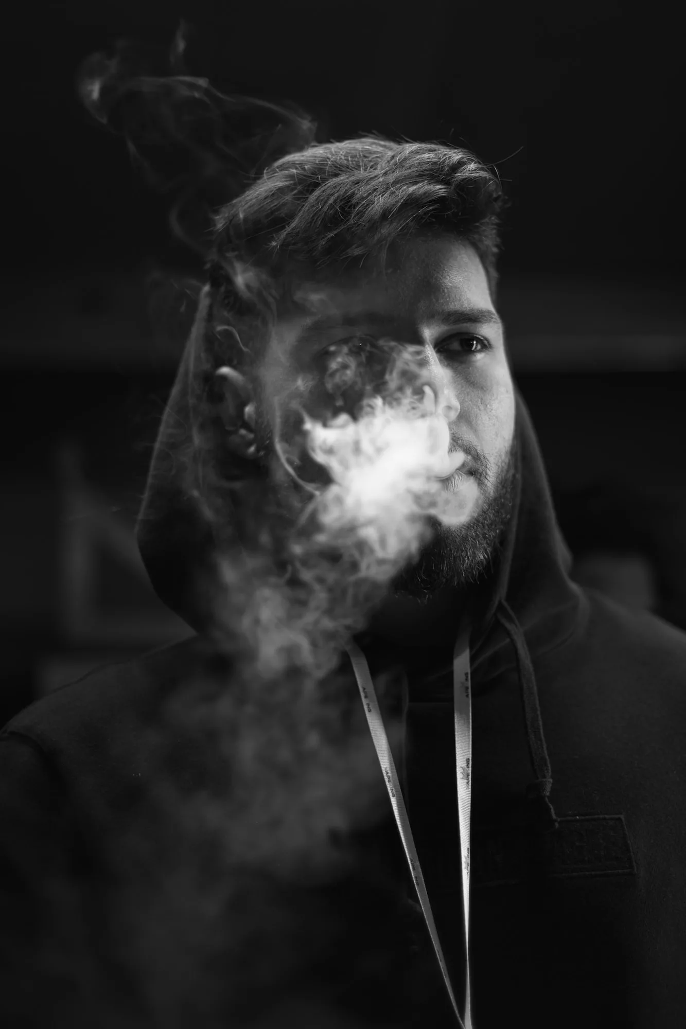 man in black hoodie smoking