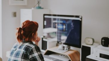 a person standing in front of a computer