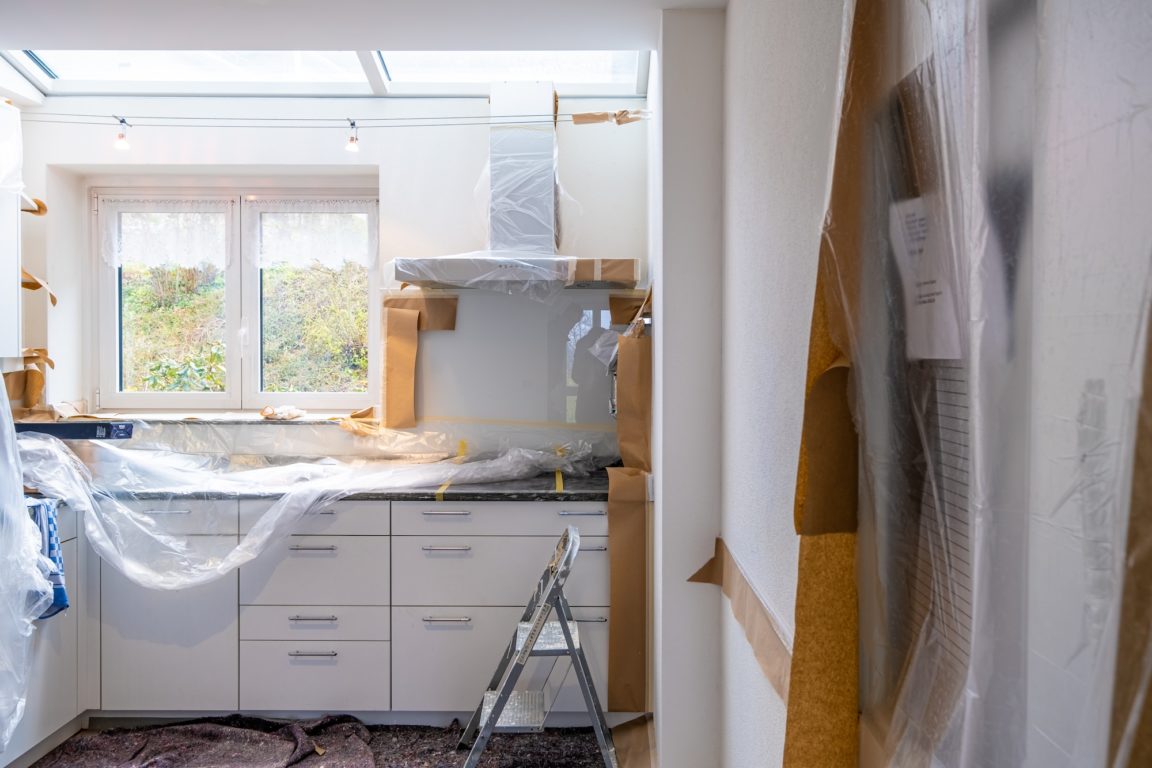 a kitchen with a sink and a shower curtain