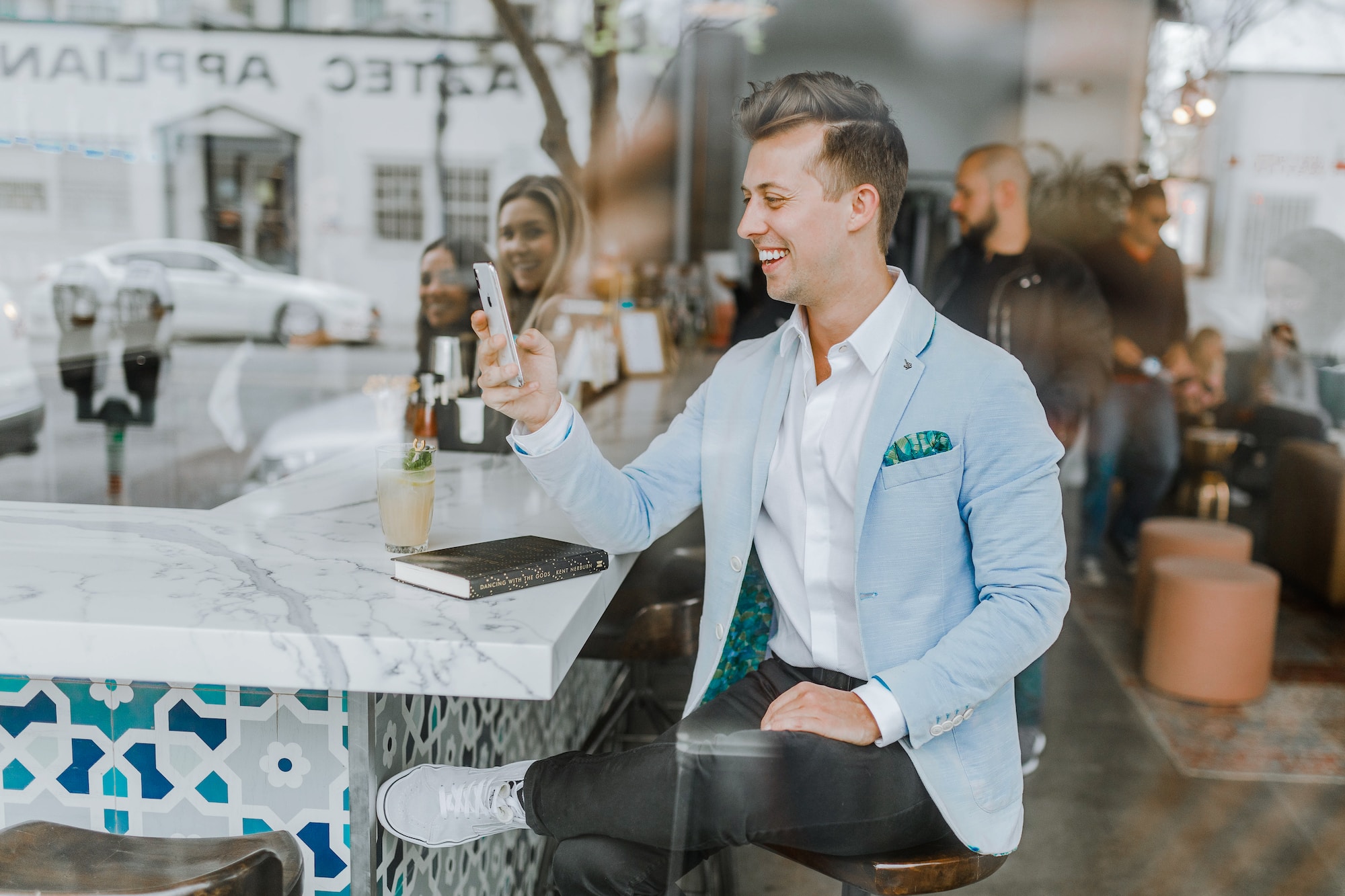 Love at First Click: The Power of Dating Sites in Finding Your Perfect Match smiling man while holding smartphone