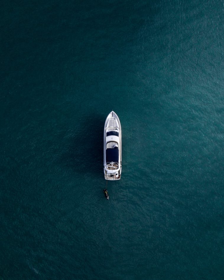 aerial photography of white yacht on calm waters
