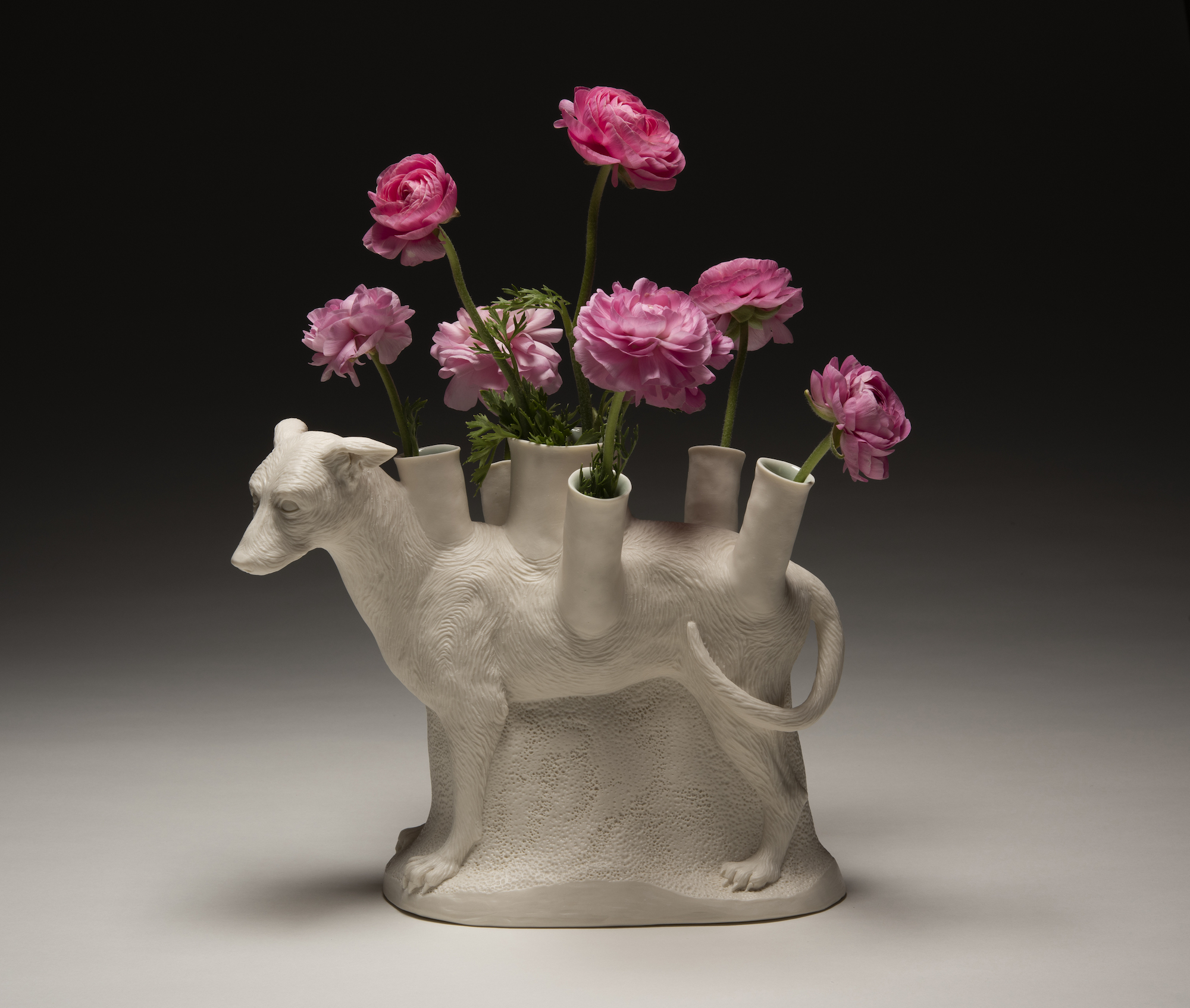 a vase filled with pink flowers on a table
