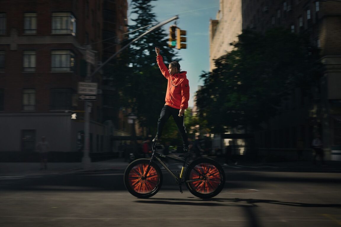 a man riding a bike on a city street