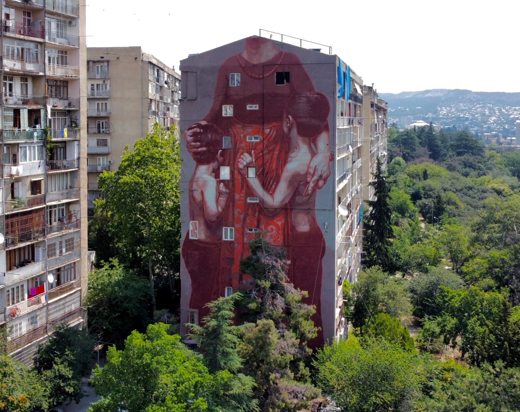 A Journey through the Vibrant Streets of the Tbilisi Mural Fest a tall building in a city
