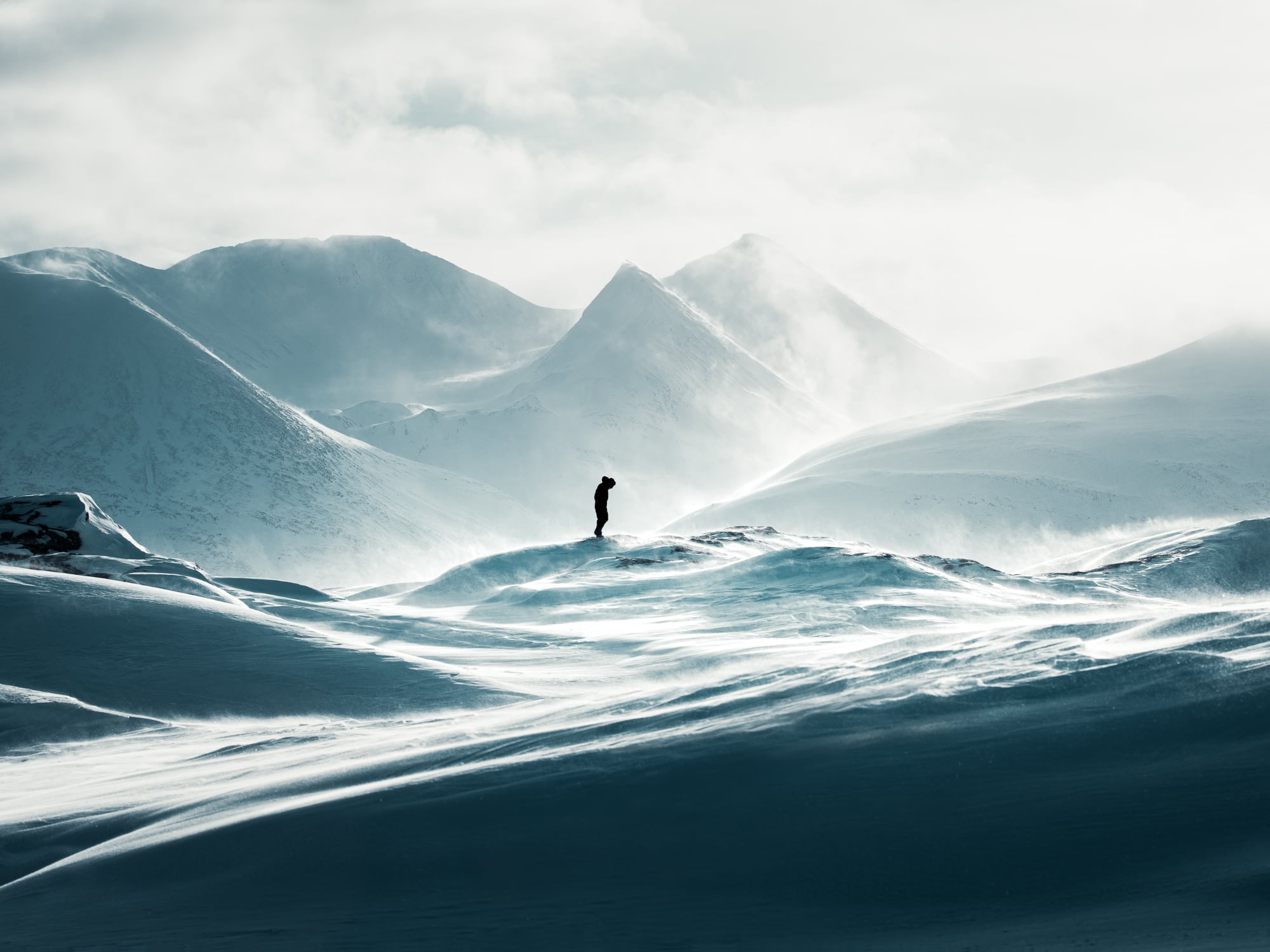 a man riding a wave on top of a mountain